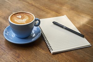 cup of coffee, notepad and pen