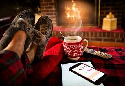 Feet up in front of the fireplace with a cup of coffee and cell phone